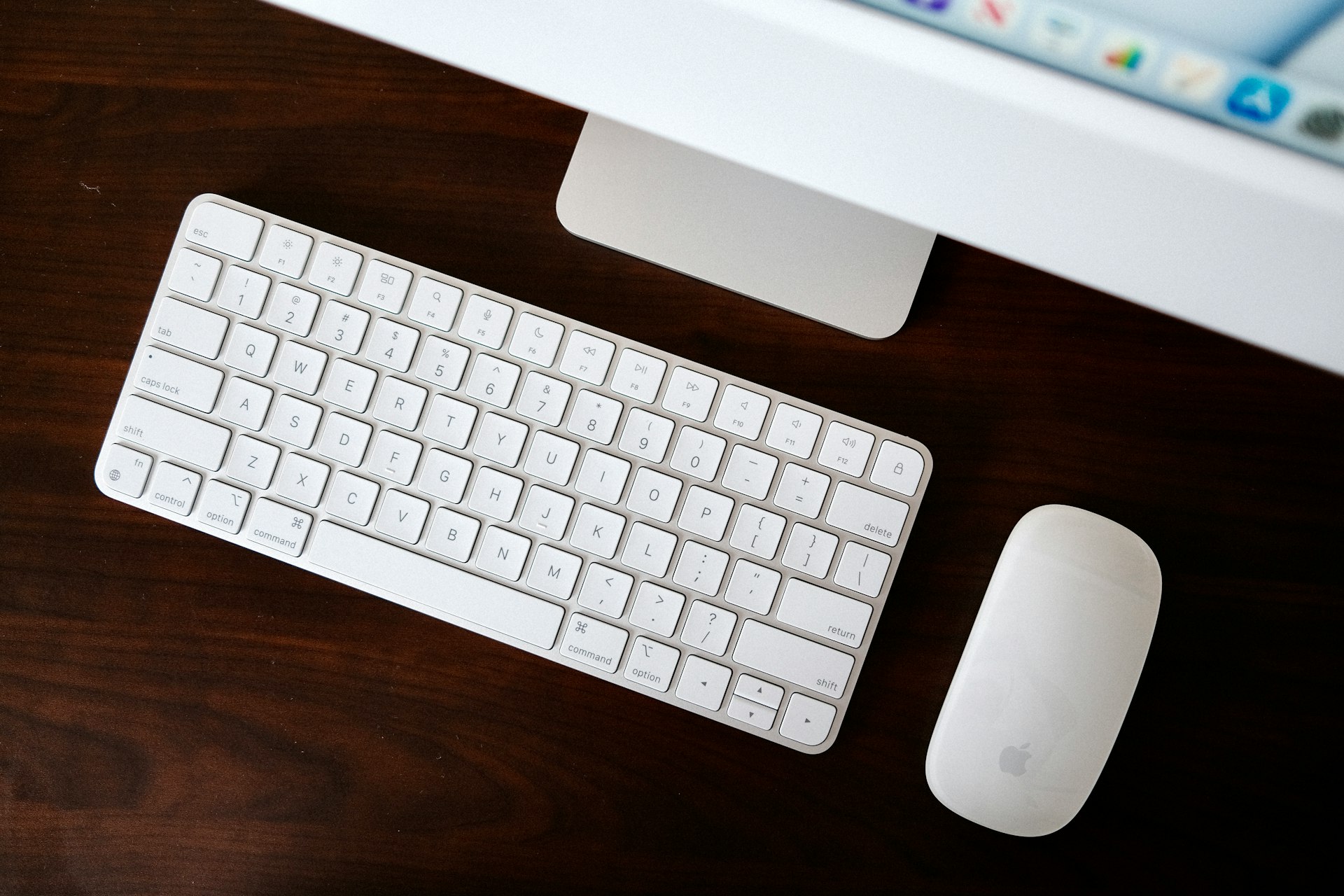 a computer keyboard and mouse on a desk